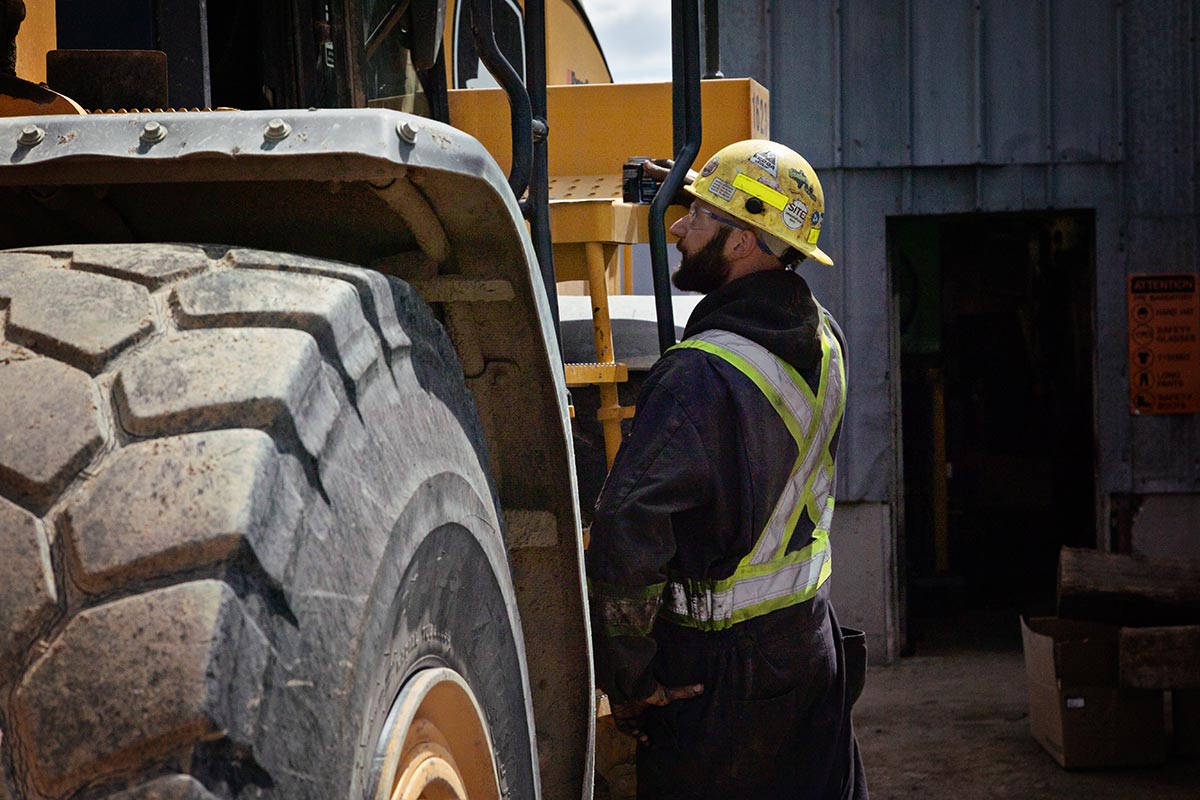Worker standing by machine Worker standing by machine