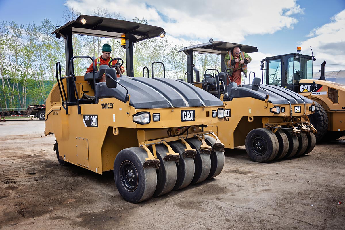 Workers on cat machines Workers on cat machines